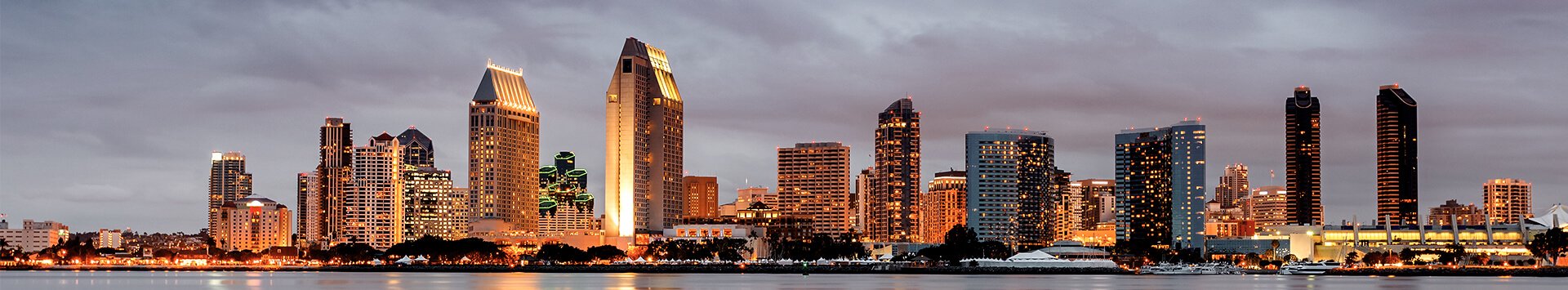 Downtown San Diego skyline shown at dusk as viewed from Coronado Ferry Landing.