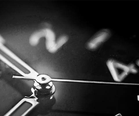 Close-up image of a black watch dial.